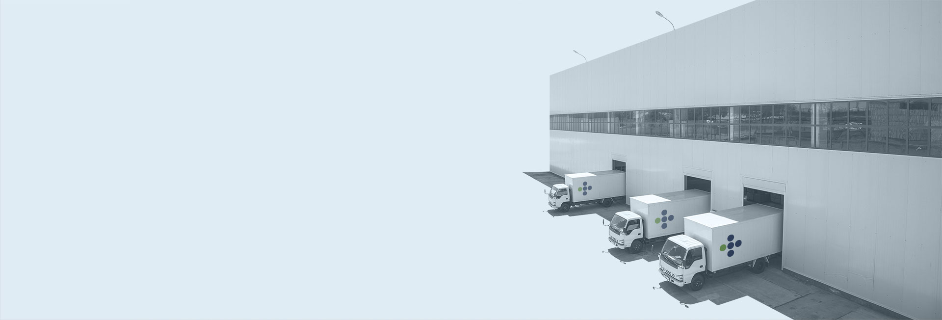 Background of a warehouse with trucks parked in loading bays with logo of S+C Partners, a full-service firm of chartered professional accountants